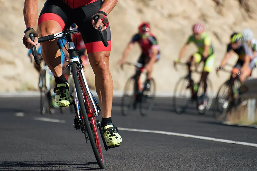 closeup of bicyclists riding on a mountain road